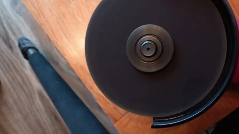 Angle Grinder Max Power Whine and Table Vibration -- Close-up on Tool Resting on Stock Footage 338170276