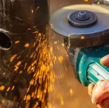 Angle grinder, pipe end. Foundation works. Locksmith. Stock Photos