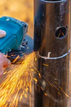 Angle grinder, pipe end. Foundation works. Locksmith. Stock Photos