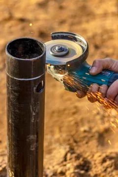 Angle grinder, pipe end. Foundation works. Locksmith. Stock Photos