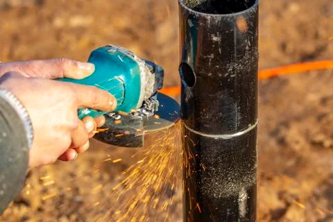 Angle grinder, pipe end. Foundation works. Locksmith. Stock Photos