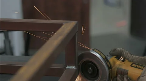 Angle grinder throwing off sparks in metal shop Stock Footage 56864328