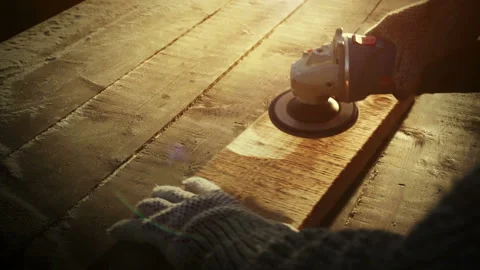 Angle grinder tool, brutal carpenter man polishes a rough plank on a wooden Stock Footage 109279615