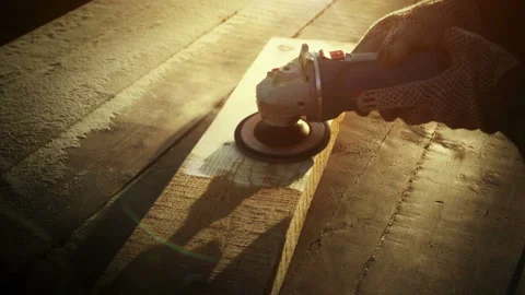 Angle grinder tool, brutal carpenter man polishes a rough plank on a wooden Stock Footage 109279816