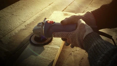 Angle grinder tool, brutal carpenter man polishes a rough plank on a wooden Stock Footage 109280057