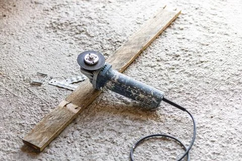 Angle grinder tool on concrete floor at construction site 스톡 사진