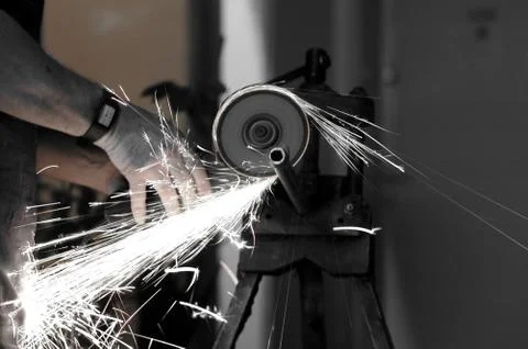 Angle grinder in use, cutting pipes for waterwork. Stock Photos