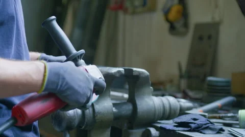Angle grinder worker hands metal sparks bench vise workshop static tripod shot Stock Footage 348106938