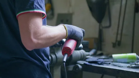 Angle grinder worker sparks workbench workshop garage static tripod shot Видео 348106579