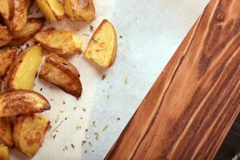 Angle half of white paper and cutting board with delicious baked golden potat Stock Photos
