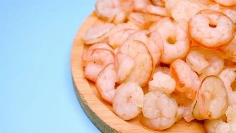 Angle pan fresh cooked unskin shrimps on blue horizontal composition Video stock 236516966