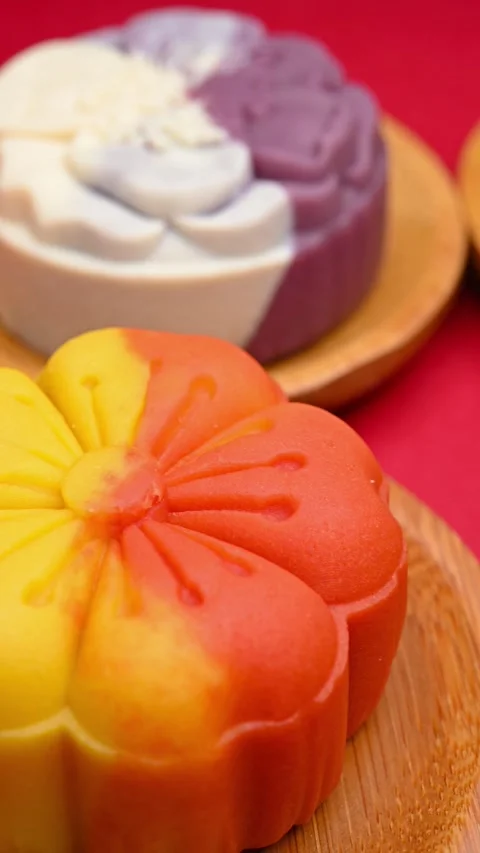 Angle pan trendy different flower shapes mooncakes on red background Stock Footage 248432090
