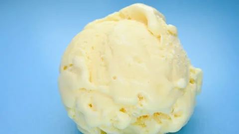 Angle pan view fresh pineapple flavor ice cream ball on blue background Video stock 199563490