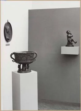Angle of a room with three bronze objects including a putto with a hose; M... Foto stock