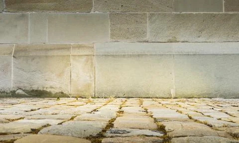 Angle of stone wall in warm tones with the foreground out of focus. Stock Photos
