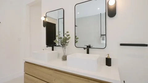 Angle view on contemporary bathroom with two modern sinks, stylish framed Stock Footage 259714897