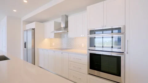 Angle view on contemporary kitchen design in cozy penthouse with new built-in Stock Footage 247086115