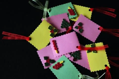 Angle view of hand crafted paper quilled christmas tags against black backgro Stock Photos
