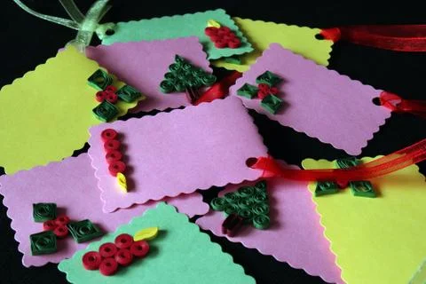 Angle view of hand crafted paper quilled christmas tags against black backgro Stock Photos
