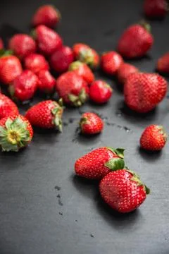 Angle view with a side, fresh strawberry harvest nicely scattered Stock Photos