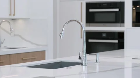 Angle view of square wash basin with faucet from stainless steel mounted into Stock Footage 245770471