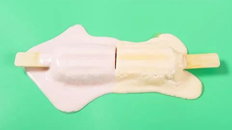 Angle view strawberries and mango flavors popsicles melting timelapse on a gr Stock Footage 196139967