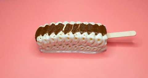 Angle view vanilla and chocolate flavor popsicle melting on a pink background Stock Footage 151659799