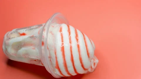 Angle view vanilla ice cream cup melting timelapse on a pink background at 8K Stock Footage 151830115