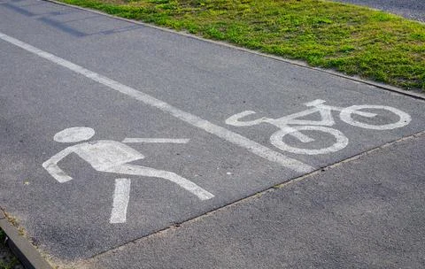 Angle view of white road marking icons on asphalt lane, pedestrian and bicy.. Stock Photos