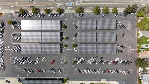 Angled Aerial View of Solar Panel Carports in Large Parking Lot Stock Photos