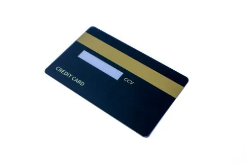 Angled back view of a dark blue credit card with magnetic stripe and CCV pane 写真素材