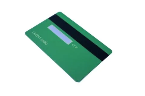 Angled back view of a green credit card with magnetic stripe and CCV panel .. Stock Photos