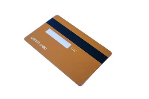 Angled back view of an orange credit card with magnetic stripe and CCV panel Stock Photos