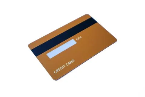 Angled back view of an orange credit card with magnetic stripe and CCV pane.. Stock Photos