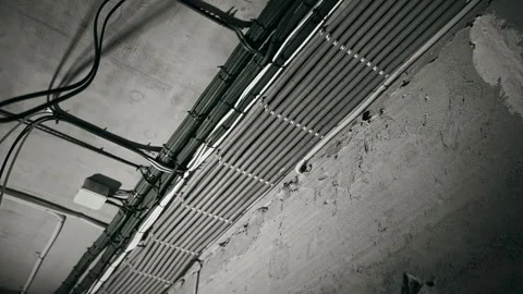 Angled Ceiling Conduit With Exposed Cables Rough Plaster Surface Monochrome Stock-Footage 323583407