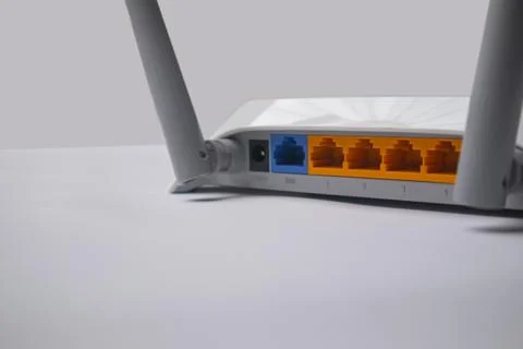 Angled close-up of the back panel of a white wireless router, displaying th.. Stock Photos