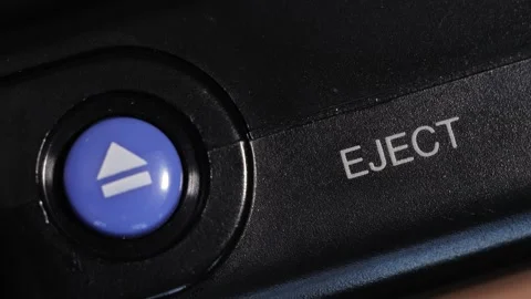 Angled Close Up Of Blue Eject Button With White Label Stock Footage 332599384