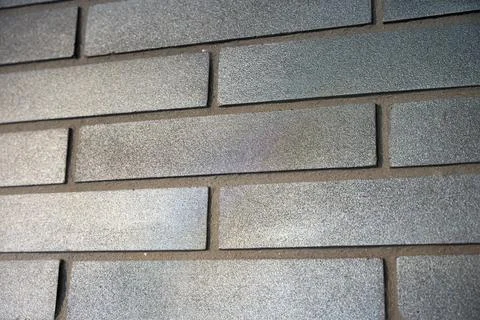 Angled Close-Up of Dark Charcoal Brick Wall Texture Stock Photos
