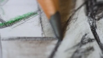Angled close up (macro) of a graphite pencil drawing a line on textured  paper. Stock Footage 85510616