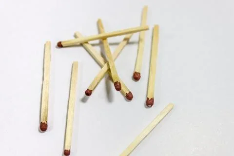Angled close-up shot of randomly separated black match head covered matches Stock Photos