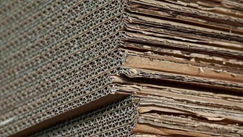 Angled close view of brown corrugated cardboard pile in warehouse Stock Footage 346248080