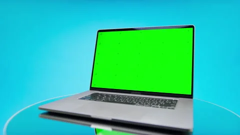 Angled Laptop With Green Screen Display on Blue Background Stock Footage 335224498