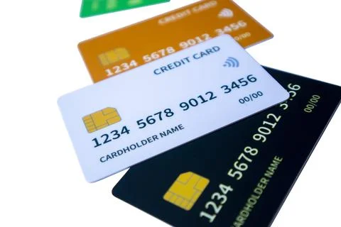 Angled perspective of overlapping multi-colored credit and debit cards on a.. Stock-Fotos
