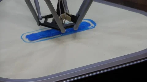 Angled Shot Of 3D Printer Printing Design On Print Bed While Extruding Plast Stock Footage 165630081