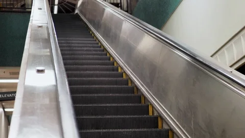 Angled shot of escalator going down in underground subway station Stock Footage 97356811