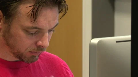 Angled Shot of an Office Worker Looking at a Computer Monitor Stock Footage 58241282