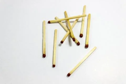Angled shot of randomly separated black match head covered matches Stock Photos