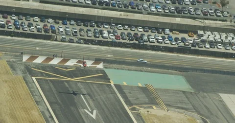 Angled shot of red plane flying over landing strip, drone aerial Stock-Footage 106357813