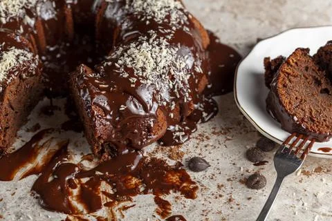 Angled side view of a gourmet round chocolate cake with coconut shreds Stock Photos