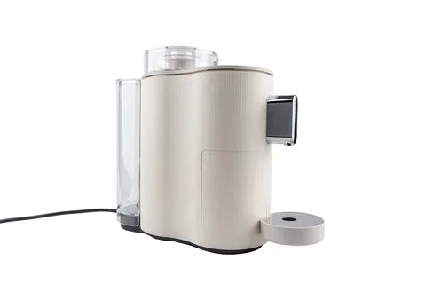 Angled side view of a sleek countertop coffee machine with chrome elements and Stock Photos